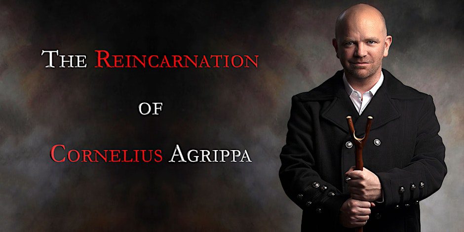 A man in a black coat holds a wooden staff, standing against a dark background reminiscent of St. Nicholas’ Collegiate Church. Text on the left reads: The Reincarnation of Cornelius Agrippa, with Reincarnation and Cornelius Agrippa in red.