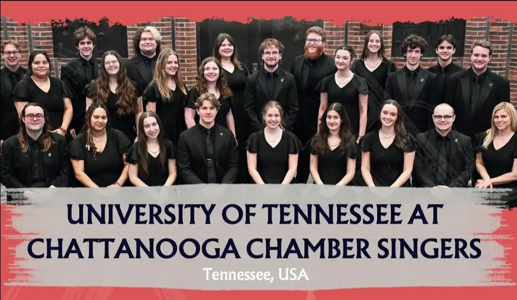 A group of 24 people, dressed in black, pose together in rows for a formal chamber choir photo. The text below reads, “University of Tennessee at Chattanooga Chamber Singers, Tennessee, USA.”.